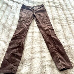 Brown jeans with slight variance in color. They do not have much stretch.